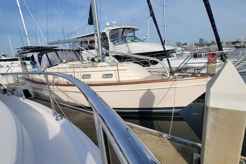 Slide: The Image of 2008 Island Packet 370 sailboat docked at marina, surrounded by other boats. - 5