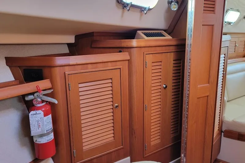 Slide: The Image of 2008 Island Packet 370 interior with wooden cabinets and a fire extinguisher. - 53