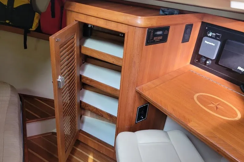 Slide: The Image of Interior of 2008 Island Packet 370 sailboat with wooden cabinetry and navigation equipment. - 56