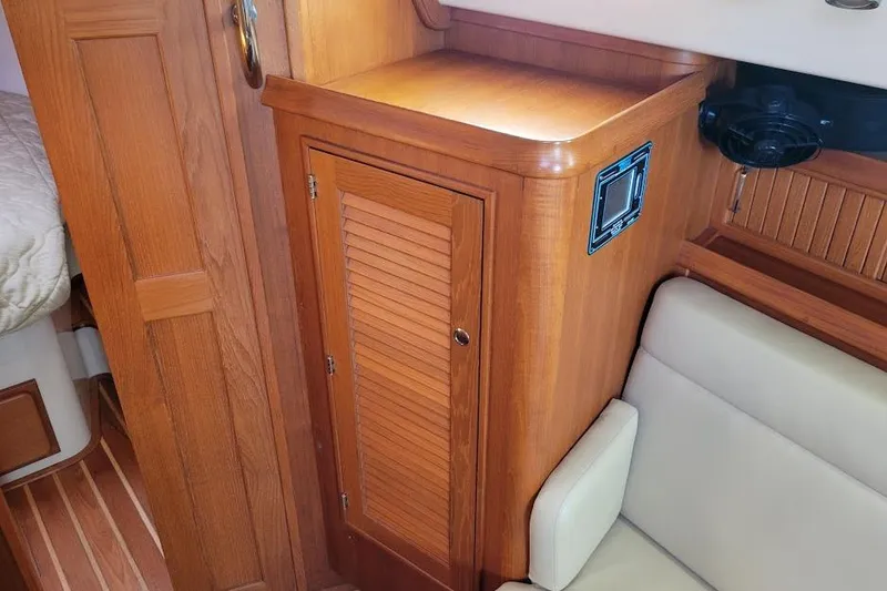 Slide: The Image of 2008 Island Packet 370 interior with wooden cabinetry and seating area. - 59