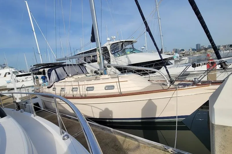 Slide: The Image of 2008 Island Packet 370 sailboat docked in marina, surrounded by other boats. - 6