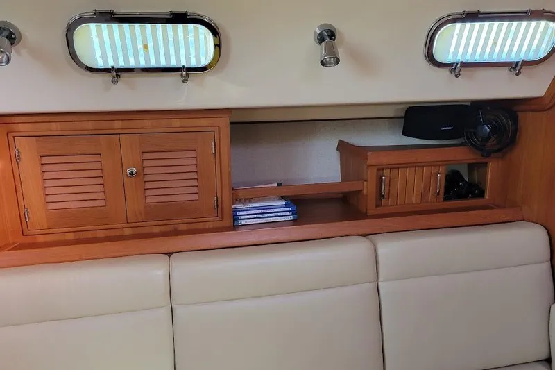 Slide: The Image of Interior of 2008 Island Packet 370 yacht with wooden cabinets and portholes. - 60