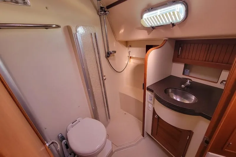 Slide: The Image of 2008 Island Packet 370 yacht bathroom with shower, sink, and toilet. - 66