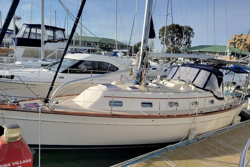 Slide: The Image of 2008 Island Packet 370 sailboat docked in marina, surrounded by other boats. - 7