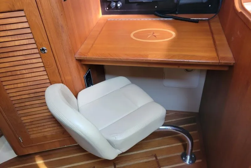 Slide: The Image of 2008 Island Packet 370 yacht interior with wooden desk and cushioned chair. - 70
