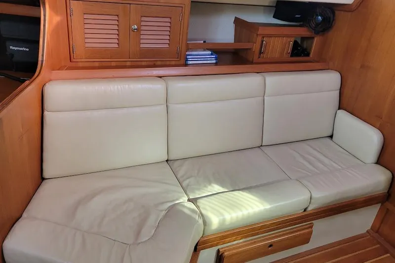 Slide: The Image of 2008 Island Packet 370 interior with cream leather seating and wooden cabinetry. - 73