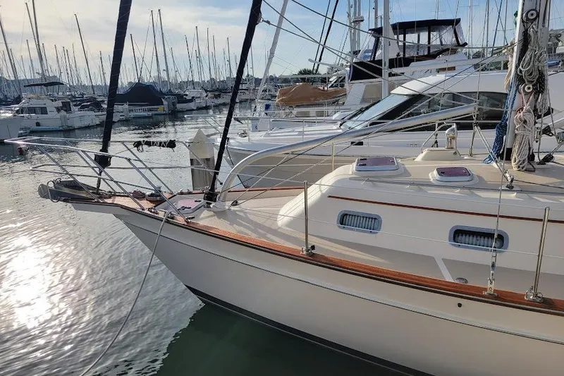 The Image of 2008 Island Packet 370 sailboat docked in a marina, surrounded by other boats. - 8