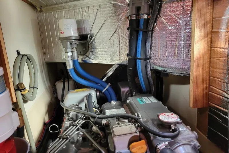 Slide: The Image of Engine compartment of a 2008 Island Packet 370 sailboat, featuring hoses and insulation. - 80
