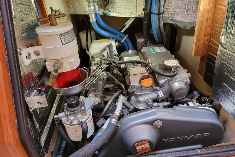 Slide: The Image of Engine compartment of a 2008 Island Packet 370 sailboat, featuring a Yanmar engine. - 81