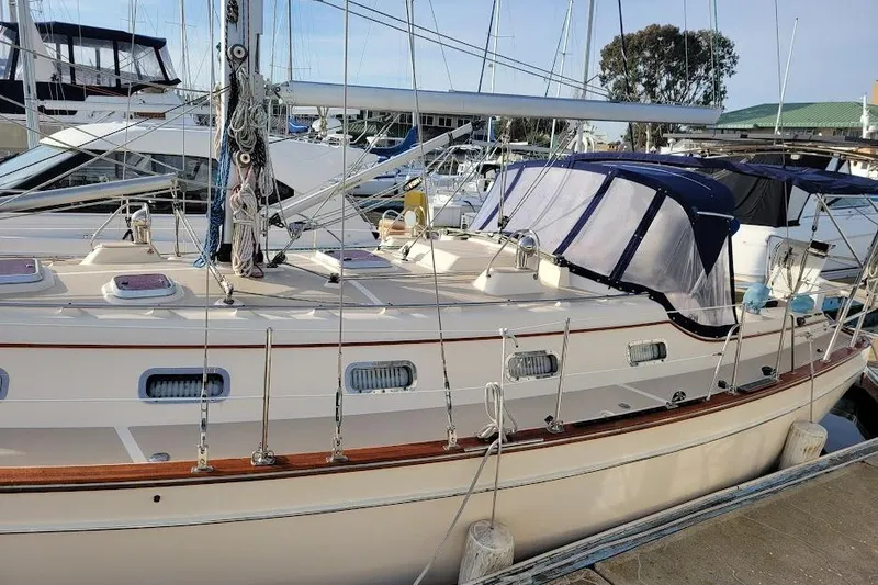 Slide: The Image of 2008 Island Packet 370 sailboat docked at marina, featuring classic design and rigging. - 9
