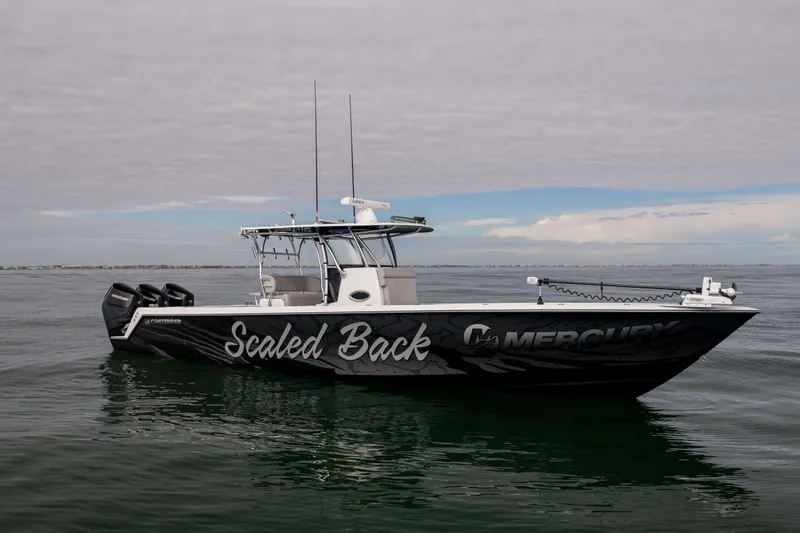 The Image of 2016 Contender 39 ST boat on water, featuring "Scaled Back" and Mercury branding. - 1