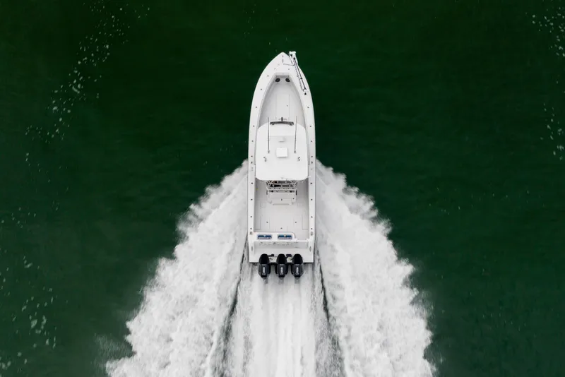 Slide: The Image of Aerial view of 2016 Contender 39 ST boat speeding on water. - 12
