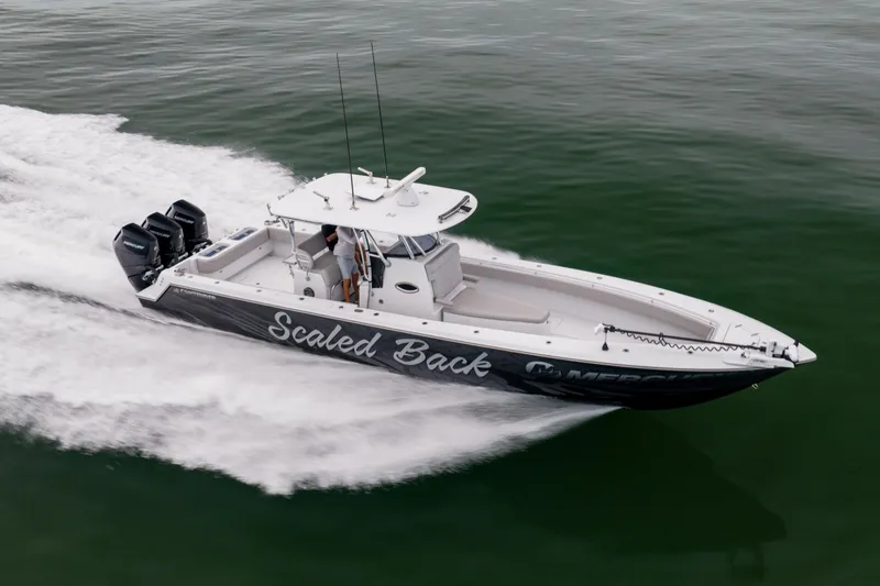 Slide: The Image of 2016 Contender 39 ST boat speeding on water with three outboard motors. - 13