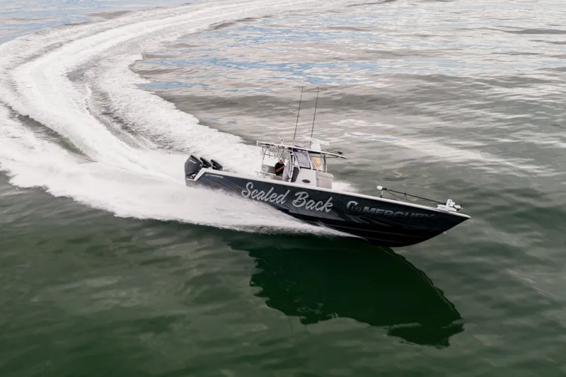 Slide: The Image of 2016 Contender 39 ST boat speeding on water, creating a dynamic wake. - 14