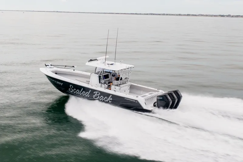 Slide: The Image of 2016 Contender 39 ST boat speeding on open water, side view. - 16