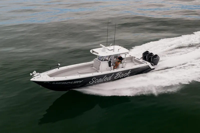 Slide: The Image of 2016 Contender 39 ST boat speeding on water with triple Mercury engines. - 18