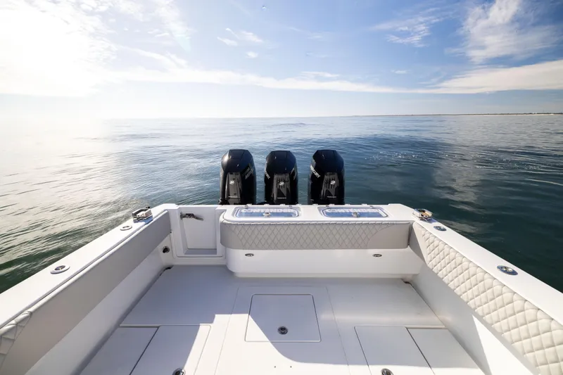 Slide: The Image of 2016 Contender 39 ST boat with triple engines on calm ocean waters. - 19