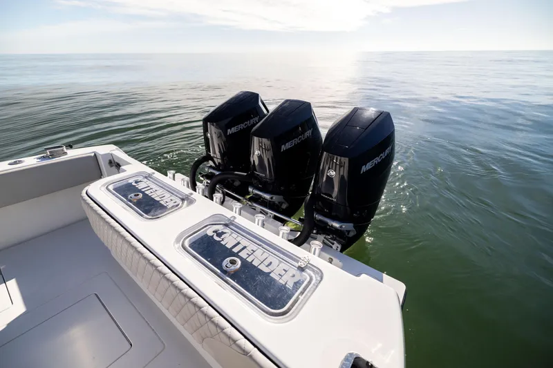 Slide: The Image of 2016 Contender 39 ST boat with triple Mercury outboard engines on calm water. - 22