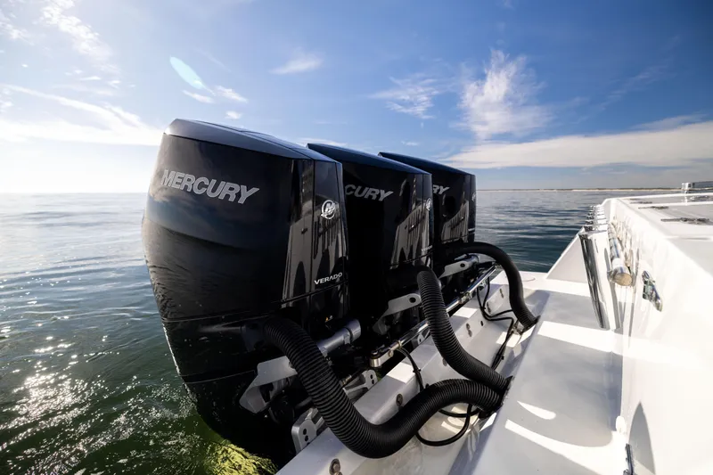Slide: The Image of 2016 Contender 39 ST boat with triple Mercury Verado engines on open water. - 23