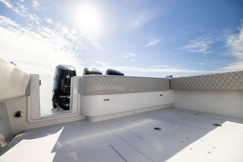 Slide: The Image of 2016 Contender 39 ST boat deck with outboard motors under a clear sky. - 24