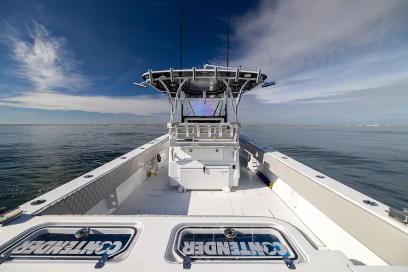 Slide: The Image of 2016 Contender 39 ST boat on calm water under a clear blue sky. - 25