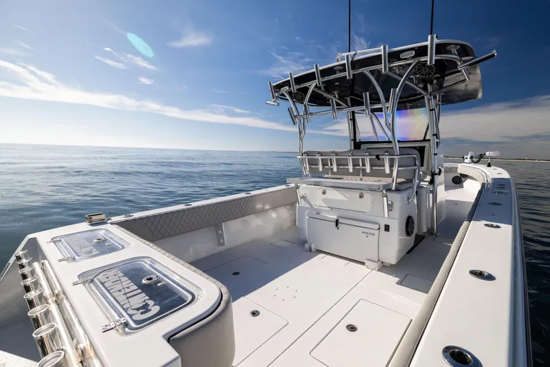 Slide: The Image of 2016 Contender 39 ST boat on open water under clear blue sky. - 26