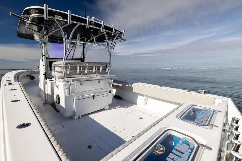 Slide: The Image of 2016 Contender 39 ST boat on calm water, featuring spacious deck and modern design. - 27