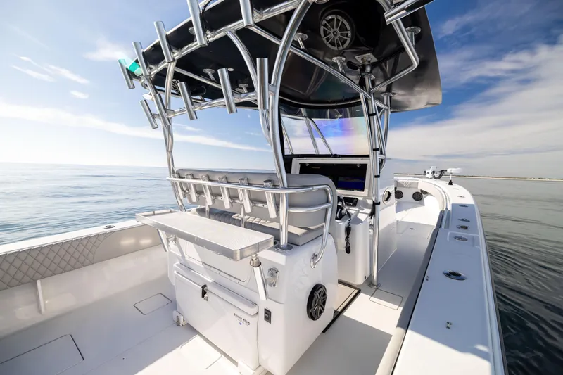 Slide: The Image of 2016 Contender 39 ST boat interior with helm, ocean view, and clear sky. - 28