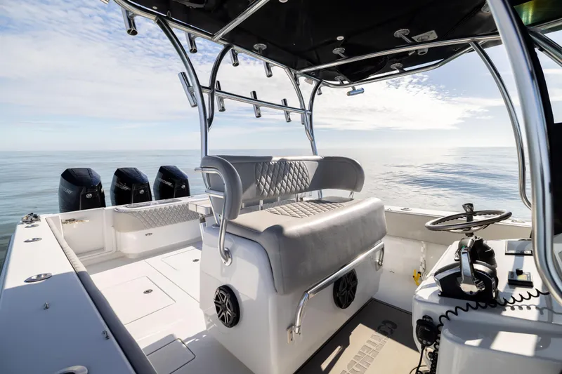 Slide: The Image of 2016 Contender 39 ST boat interior with helm, seating, and multiple outboard engines. - 30