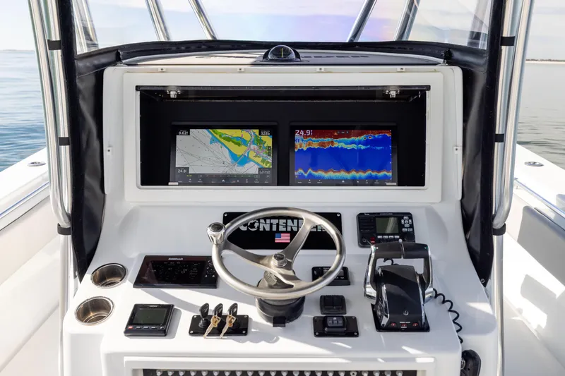 Slide: The Image of 2016 Contender 39 ST boat dashboard with navigation screens and controls. - 35