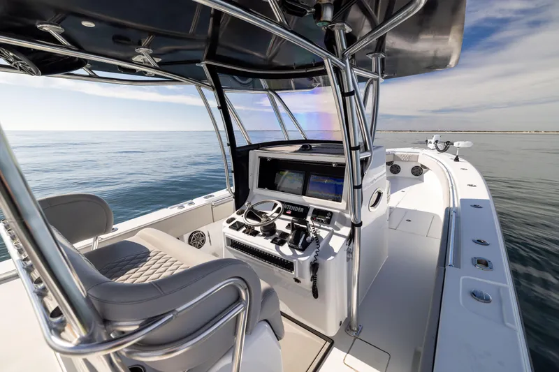 Slide: The Image of 2016 Contender 39 ST boat interior with helm, steering wheel, and ocean view. - 36