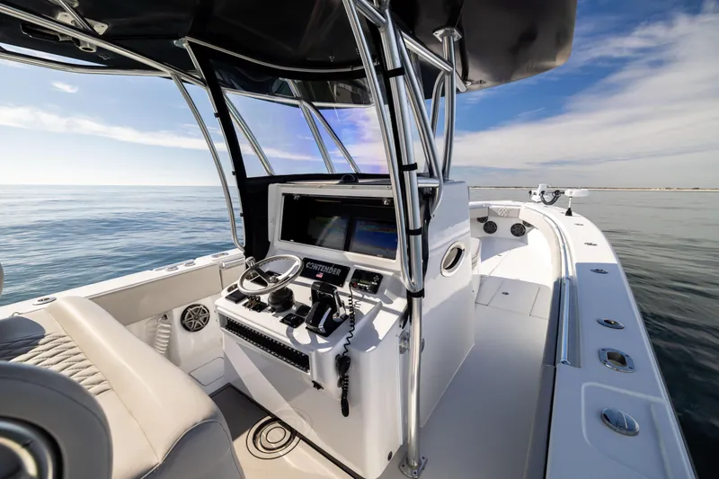 Slide: The Image of 2016 Contender 39 ST boat interior with steering console on calm ocean. - 37