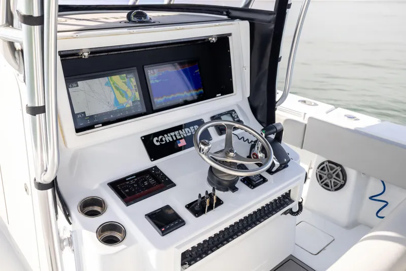 Slide: The Image of Helm of 2016 Contender 39 ST boat with navigation screens and steering wheel. - 39