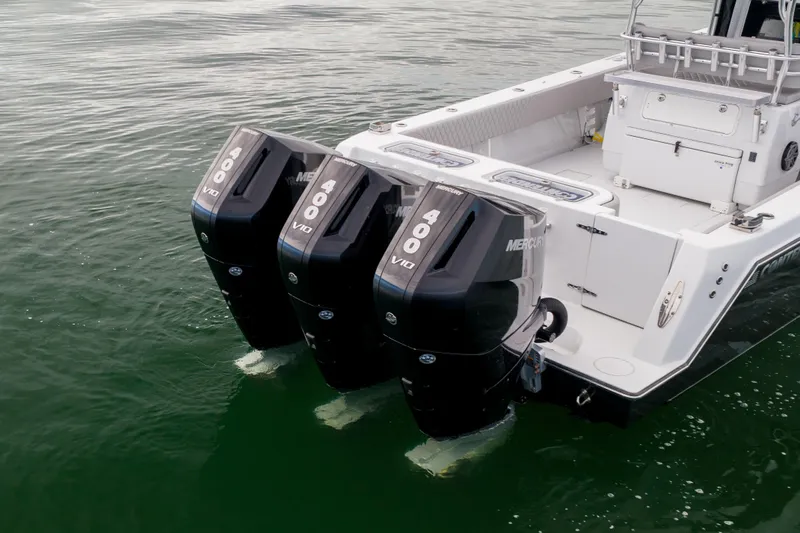 Slide: The Image of 2016 Contender 39 ST boat with triple Mercury 400 V10 outboard engines on water. - 4