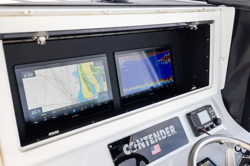 Slide: The Image of Dashboard of 2016 Contender 39 ST boat with dual Garmin navigation screens. - 40