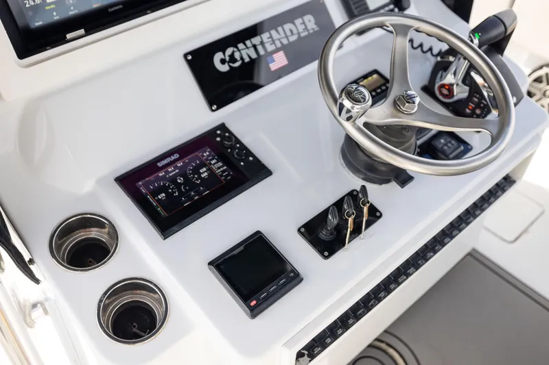 Slide: The Image of 2016 Contender 39 ST boat dashboard with steering wheel and electronic controls. - 41