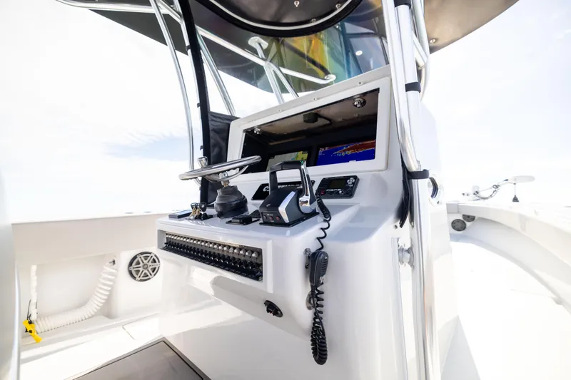Slide: The Image of 2016 Contender 39 ST boat cockpit with modern navigation controls and steering wheel. - 44