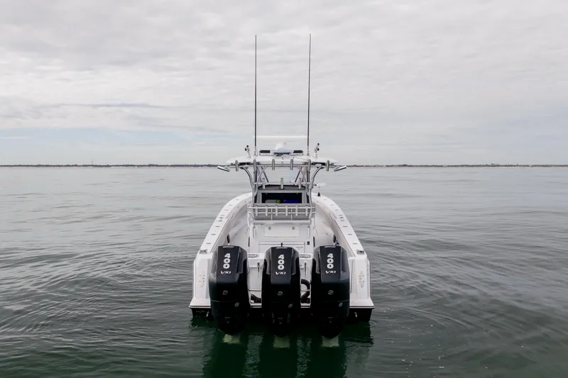 Slide: The Image of 2016 Contender 39 ST boat with triple 400 V10 engines on calm water. - 5