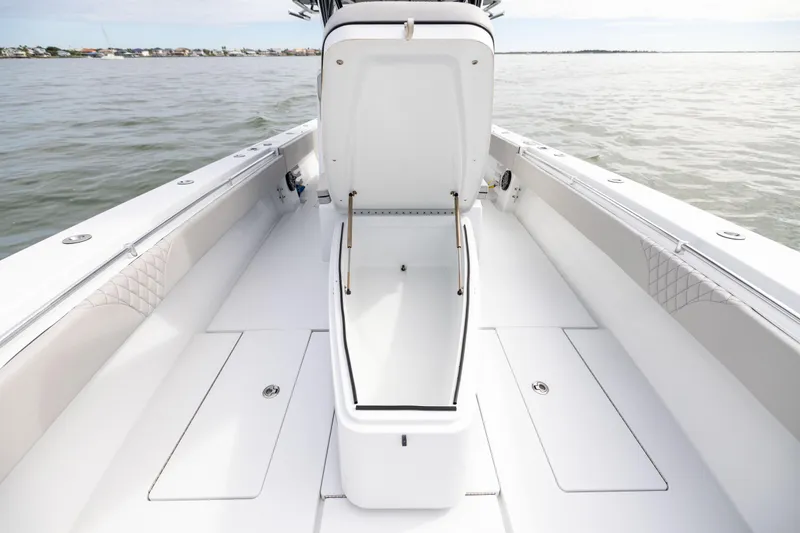 Slide: The Image of 2016 Contender 39 ST boat with open storage compartment on calm water. - 54