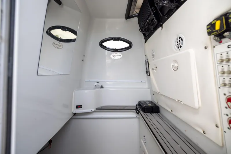 Slide: The Image of 2016 Contender 39 ST boat interior with control panel and porthole window. - 61