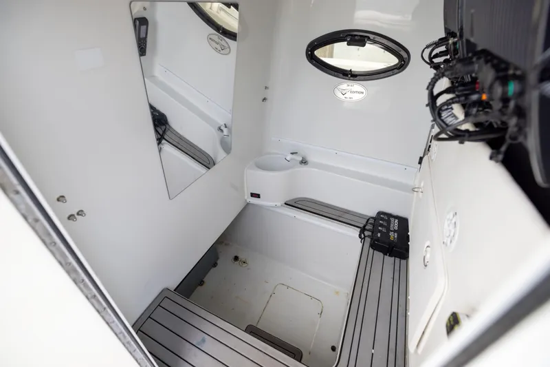 Slide: The Image of Interior of 2016 Contender 39 ST boat, featuring a compact cabin with seating and equipment. - 62