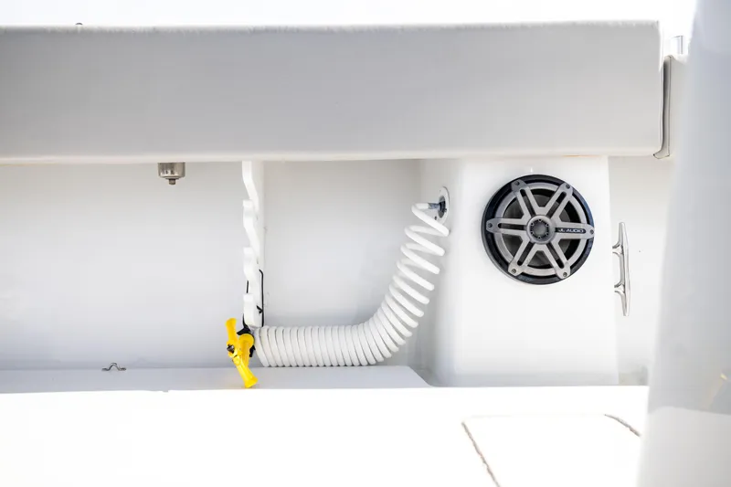 Slide: The Image of 2016 Contender 39 ST boat interior with coiled hose and JL Audio speaker. - 63