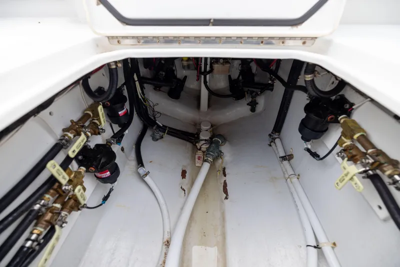 Slide: The Image of 2016 Contender 39 ST boat interior showing plumbing and wiring systems. - 69