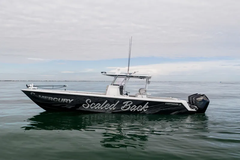 Slide: The Image of 2016 Contender 39 ST boat named "Scaled Back" on calm ocean waters. - 7