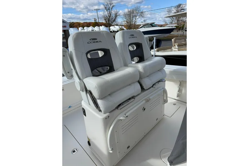 Slide: The Image of 2022 Cobia 262 Center Console boat with dual cushioned seats. - 11
