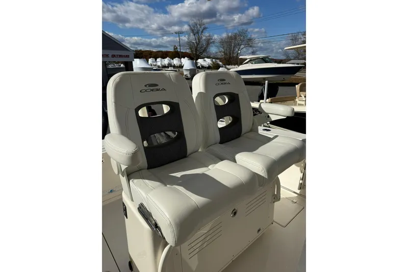 Slide: The Image of 2022 Cobia 262 Center Console boat seats under a sunny sky. - 13