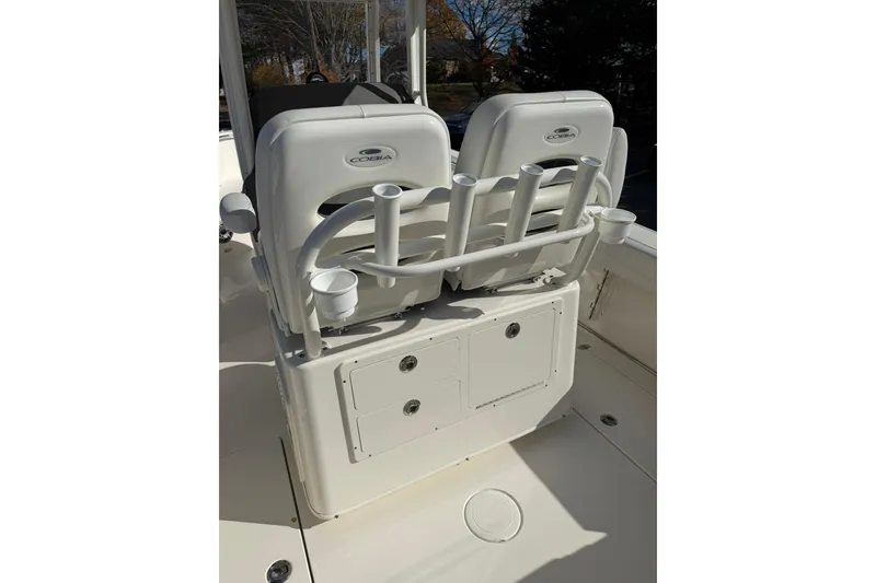 Slide: The Image of 2022 Cobia 262 Center Console boat seating with rod holders and storage compartments. - 14