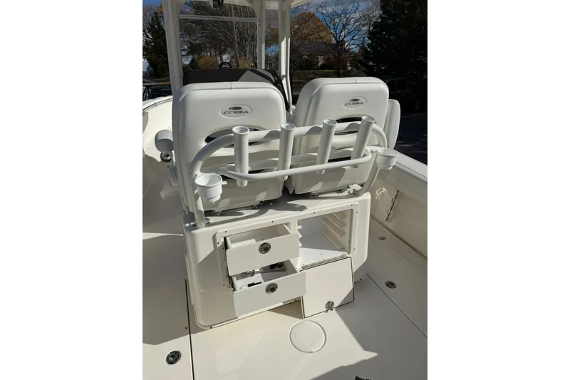 Slide: The Image of 2022 Cobia 262 Center Console boat interior with rod holders and storage compartments. - 15