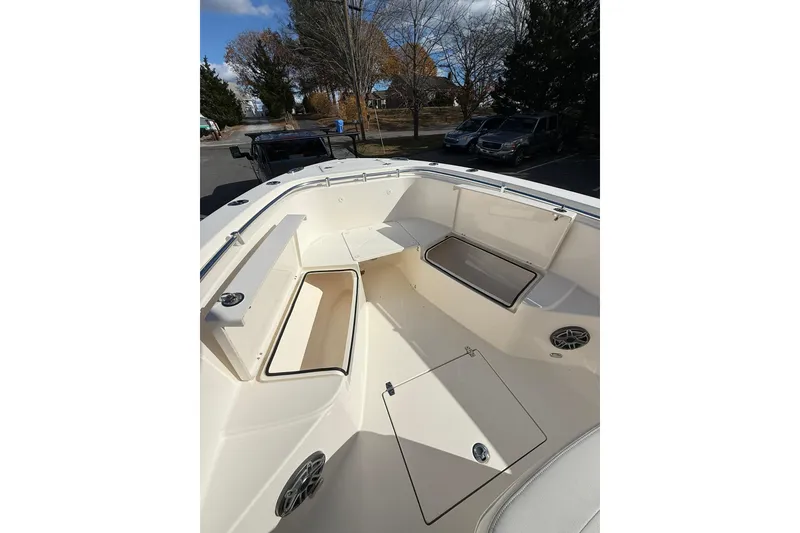 Slide: The Image of 2022 Cobia 262 Center Console boat interior with storage compartments and seating. - 17
