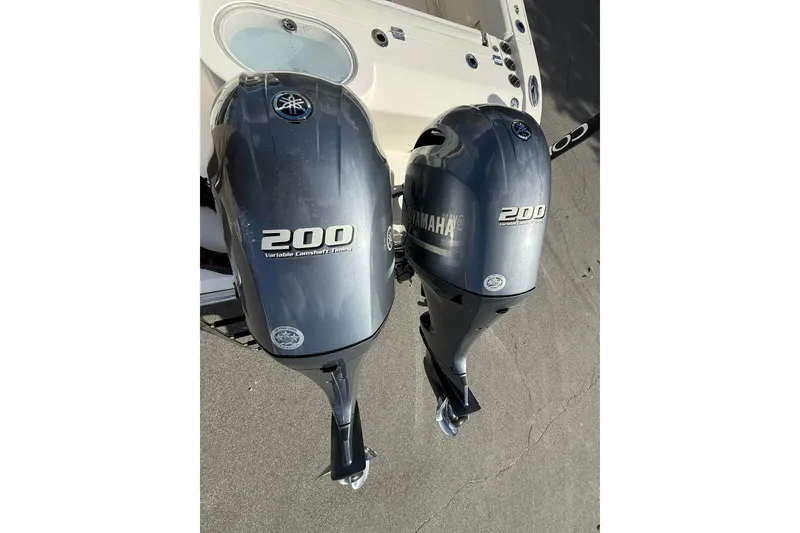 Slide: The Image of Twin Yamaha 200 engines on a 2022 Cobia 262 Center Console boat. - 5